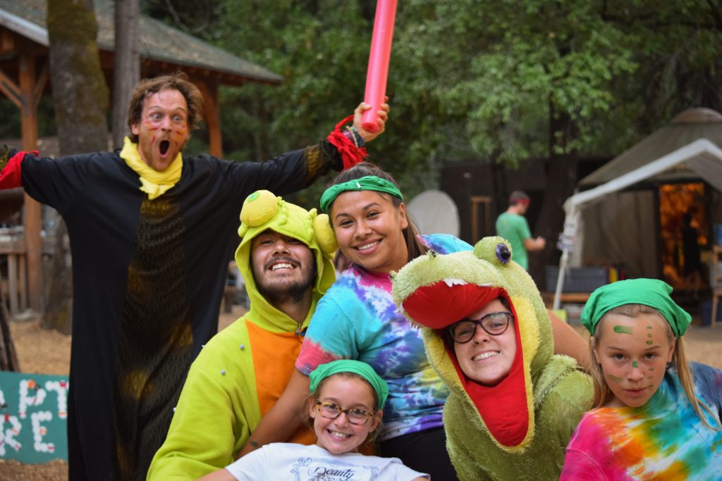 Summer Camp Counselors In Dinosaur Costumes